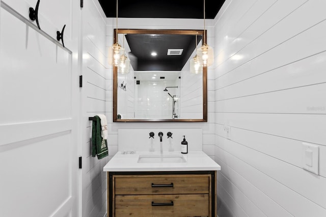 bathroom featuring walk in shower and vanity