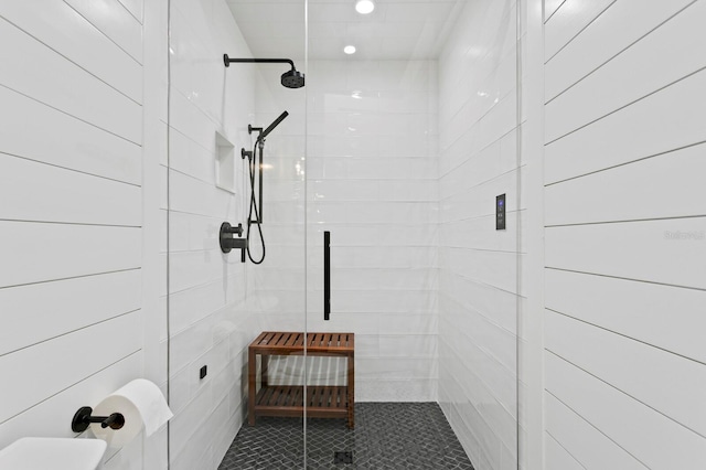 bathroom with tile patterned floors and a tile shower