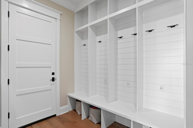 mudroom with ornamental molding and hardwood / wood-style flooring