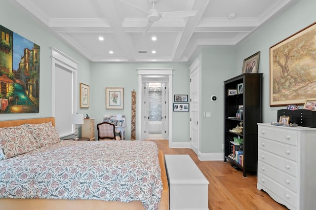 bedroom with coffered ceiling, ceiling fan, light wood-type flooring, crown molding, and beamed ceiling