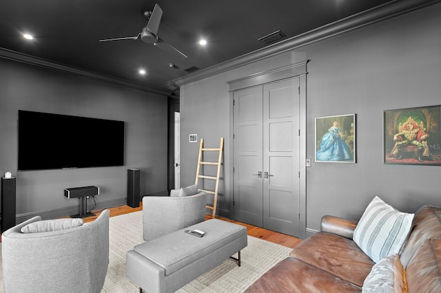 interior space featuring light wood-type flooring, ceiling fan, and ornamental molding