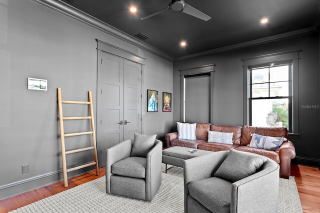 living room with ceiling fan, ornamental molding, and hardwood / wood-style flooring