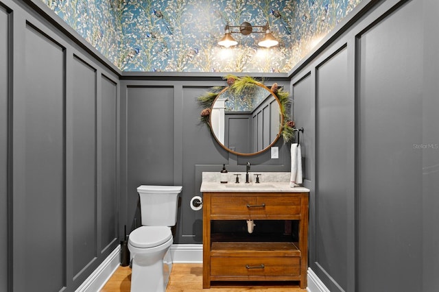 bathroom featuring hardwood / wood-style floors, toilet, and vanity