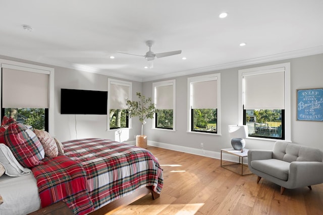 bedroom featuring ceiling fan, ornamental molding, and light hardwood / wood-style flooring