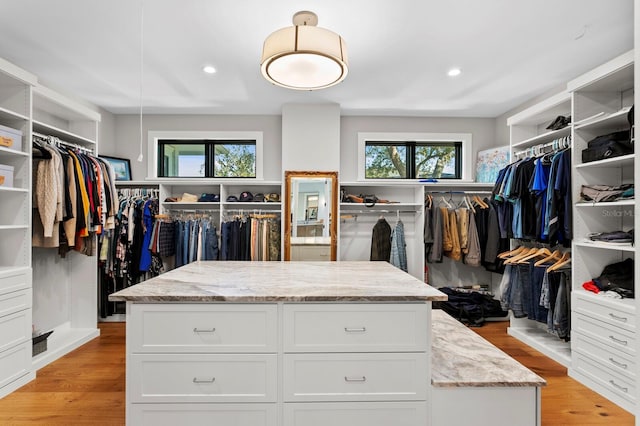 walk in closet with light wood-type flooring