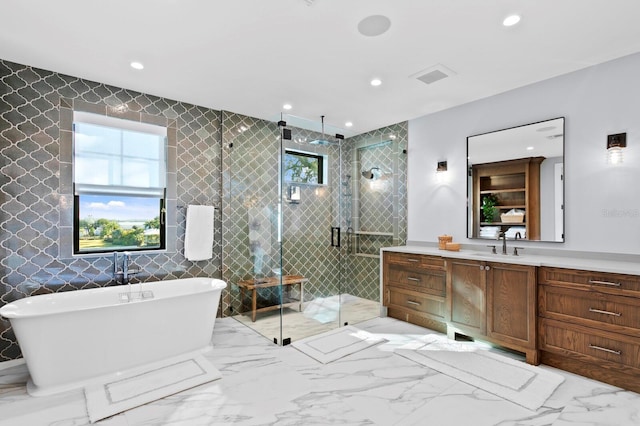 bathroom featuring tile walls, vanity, and separate shower and tub