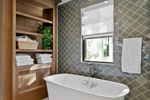 bathroom with built in features and a tub to relax in