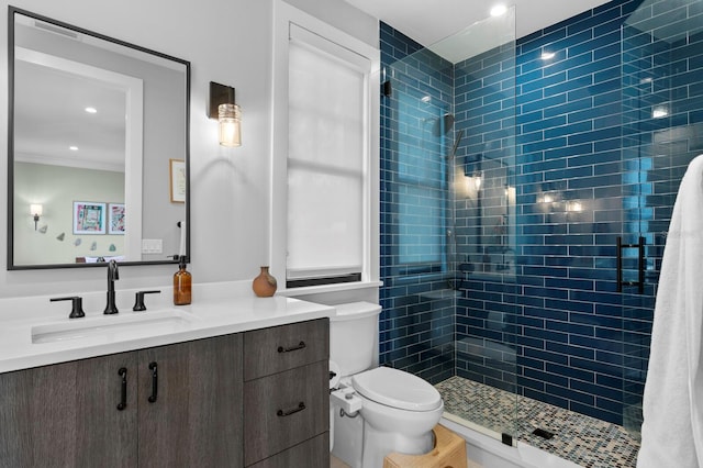 bathroom with walk in shower, vanity, toilet, and crown molding