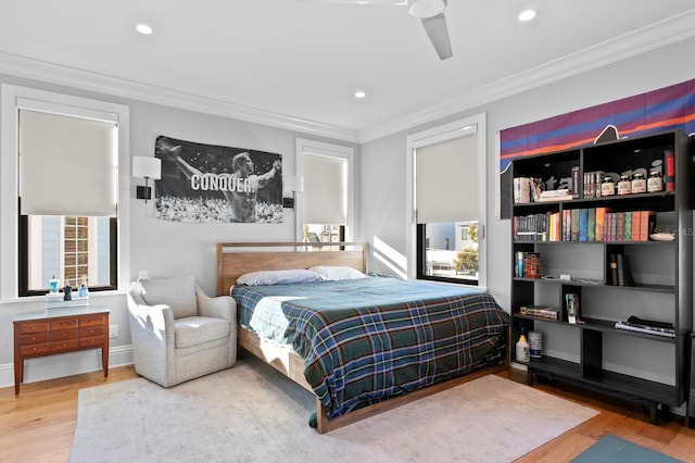 bedroom featuring ceiling fan, ornamental molding, and hardwood / wood-style floors