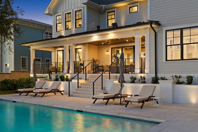 rear view of house featuring ceiling fan and a patio area