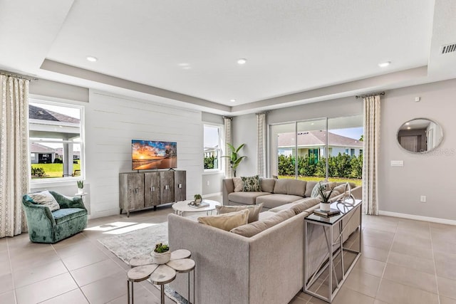 tiled living room with a raised ceiling