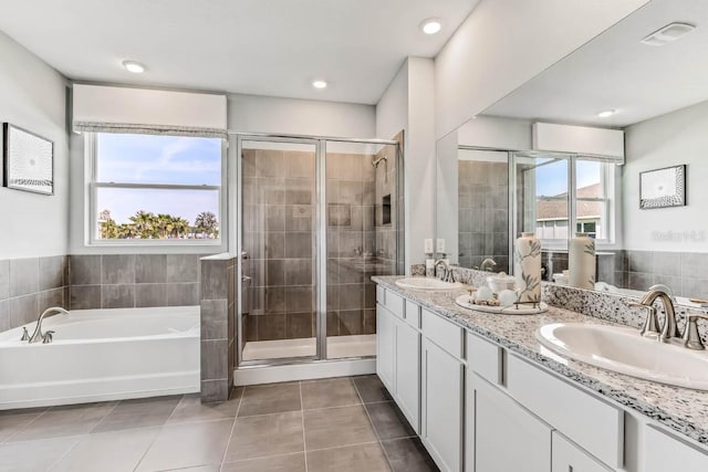 bathroom with tile patterned floors, plenty of natural light, and independent shower and bath