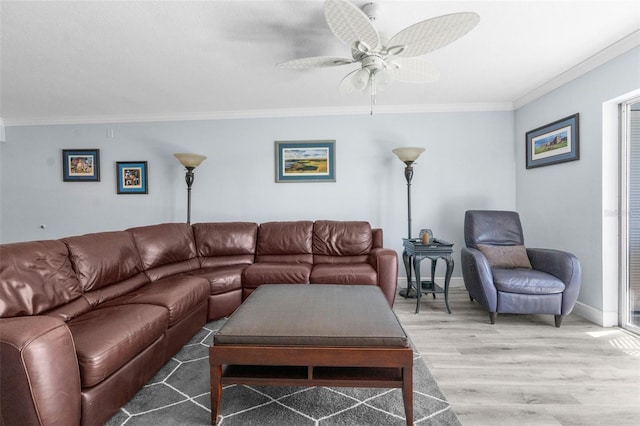 living room with hardwood / wood-style floors, ceiling fan, and ornamental molding