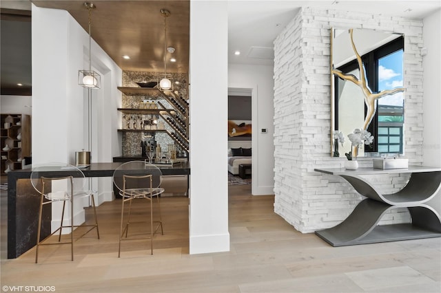 interior space featuring light hardwood / wood-style flooring and hanging light fixtures