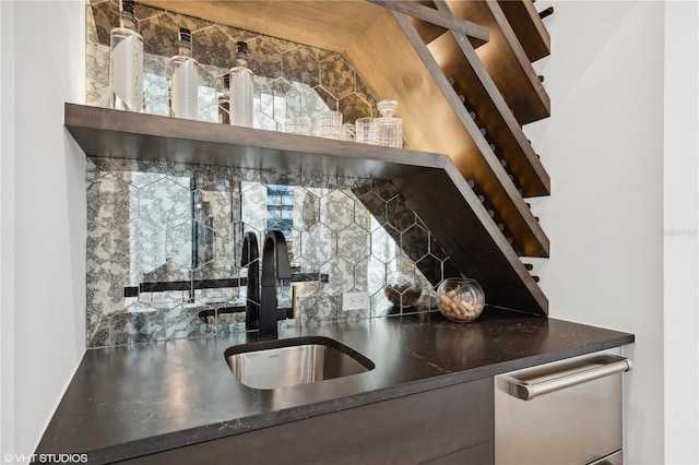 kitchen featuring dishwasher, tasteful backsplash, and sink