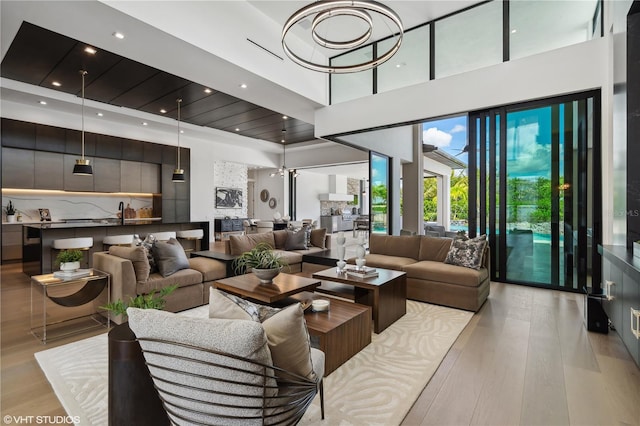 living room with a high ceiling and light hardwood / wood-style flooring