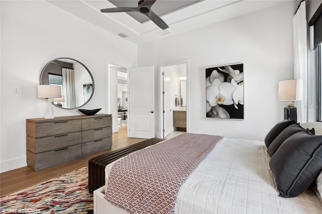 bedroom featuring ceiling fan, light hardwood / wood-style floors, and ensuite bathroom