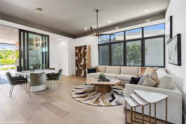 living room with ceiling fan and light hardwood / wood-style floors