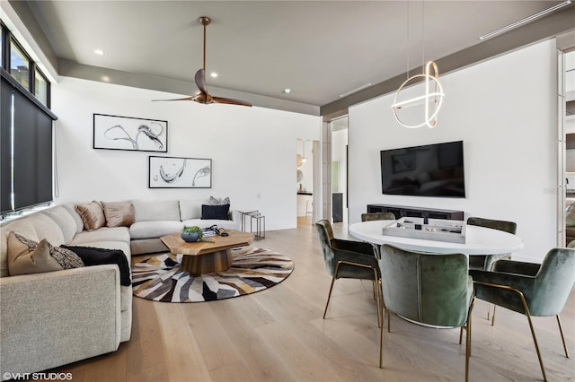 living room with hardwood / wood-style floors and ceiling fan