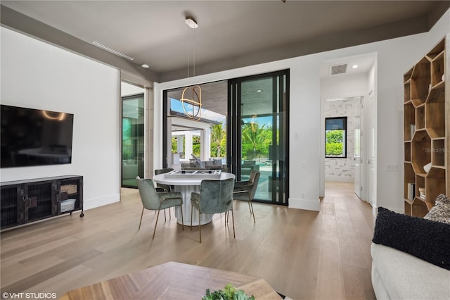 dining area with light hardwood / wood-style floors