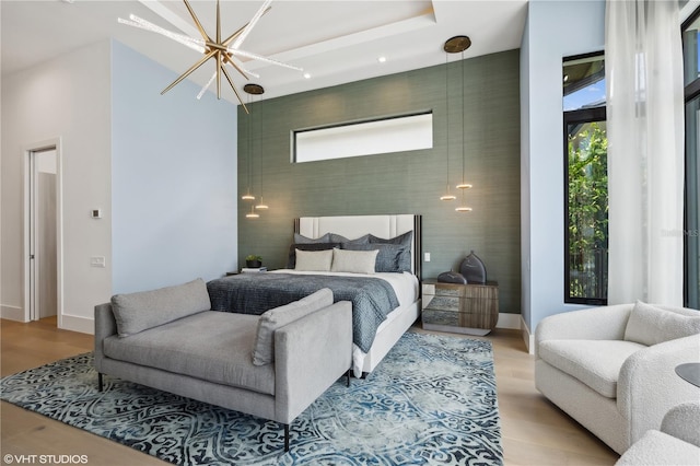 bedroom featuring light hardwood / wood-style floors and a notable chandelier