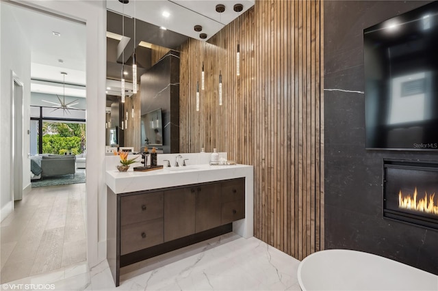 bathroom with wood-type flooring, vanity, and wood walls