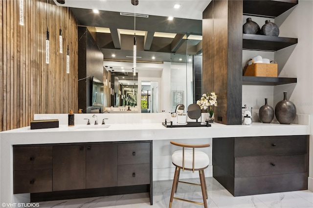 bathroom with vanity and wood walls