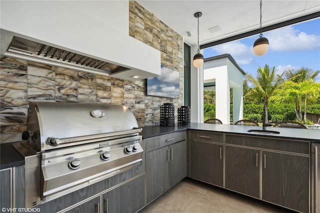 view of patio / terrace featuring sink, a grill, and exterior kitchen