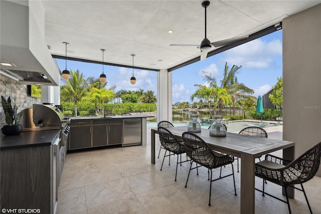 view of patio / terrace featuring area for grilling, a water view, and sink