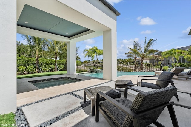 view of pool with an in ground hot tub, pool water feature, and a patio