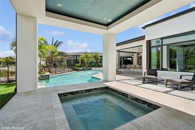 view of swimming pool featuring an in ground hot tub, pool water feature, a patio, and an outdoor hangout area