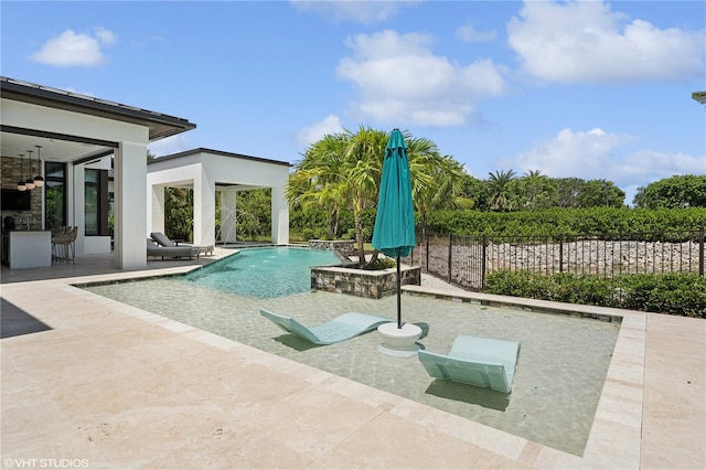 view of swimming pool featuring pool water feature, an outdoor bar, and a patio