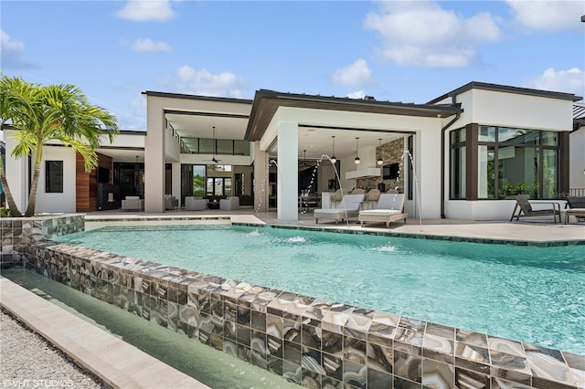 back of property featuring pool water feature, ceiling fan, and a patio area