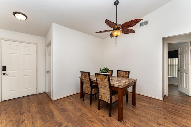 dining room with ceiling fan, dark hardwood / wood-style flooring, and lofted ceiling