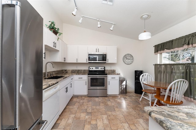 kitchen with hanging light fixtures, white cabinetry, sink, and stainless steel appliances