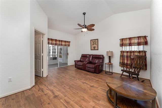 living room with hardwood / wood-style floors, vaulted ceiling, and ceiling fan