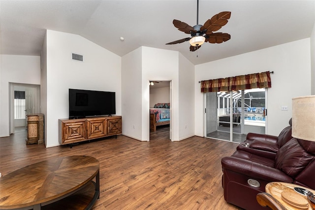 living room with ceiling fan, dark wood-type flooring, and lofted ceiling