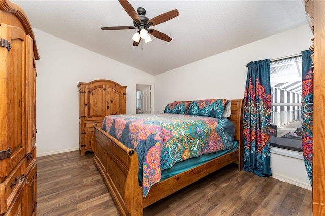 bedroom featuring dark hardwood / wood-style floors, ceiling fan, and lofted ceiling