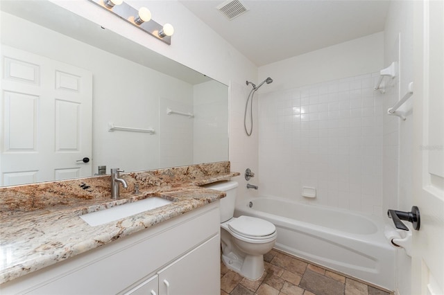 full bathroom with vanity, tiled shower / bath combo, and toilet