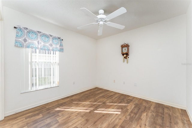 unfurnished room with hardwood / wood-style flooring and ceiling fan