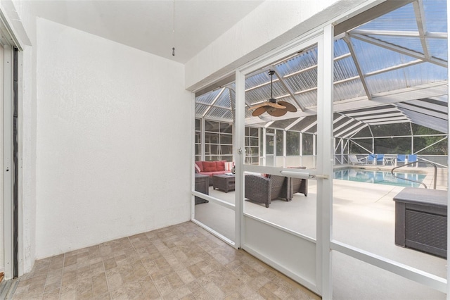 unfurnished sunroom with vaulted ceiling and a swimming pool