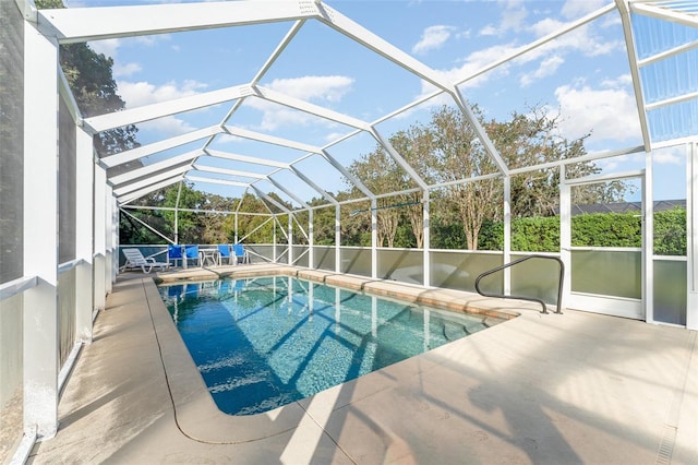 view of swimming pool with a lanai and a patio