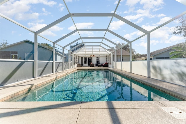 view of pool featuring ceiling fan, a lanai, and a patio