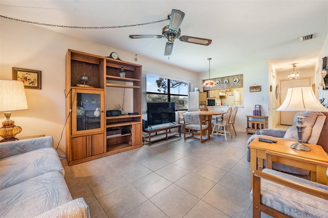 living room with tile patterned flooring and ceiling fan