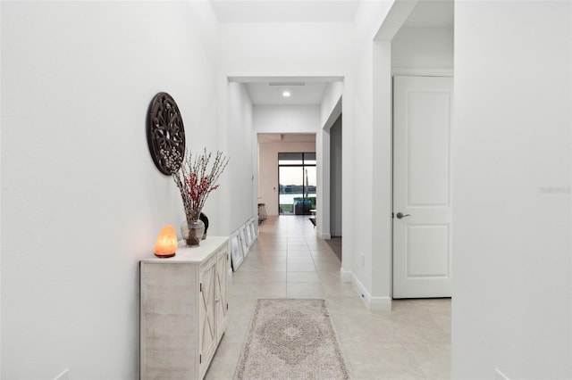 hall featuring light tile patterned floors