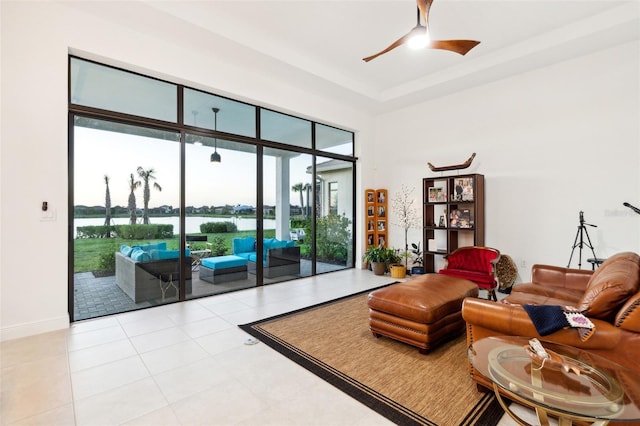 interior space with ceiling fan and a water view