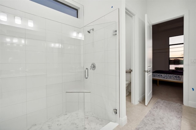 bathroom featuring tile patterned floors, toilet, and an enclosed shower