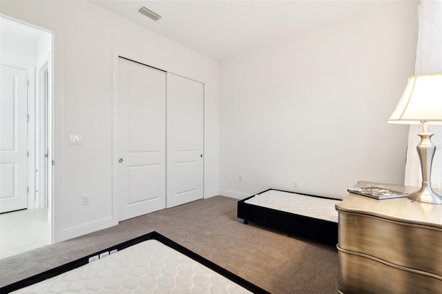 bedroom with a closet and light colored carpet