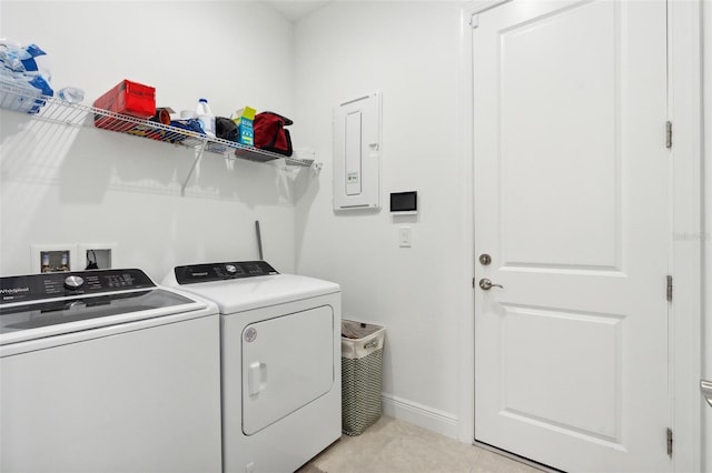 laundry room featuring light tile patterned floors, electric panel, and separate washer and dryer