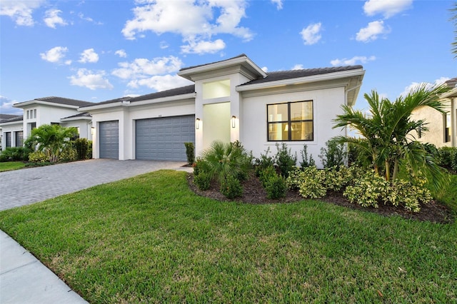 9132 Bernini Pl, Sarasota, FL 34240 - view of front of house featuring a garage, decorative driveway, stucco siding, and a front lawn